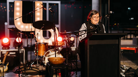 Aunty Colleen speaking at lectern on La Boite stage. Image credit: Markus Ravik
