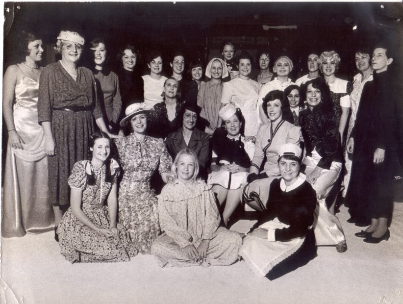 The cast of The Women, 1975. Jennifer Blocksidge is left front row, second from the end with broad-brimmed hat.