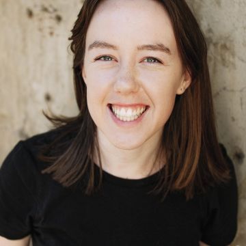Woman with mid-length brown hair smiling at camera