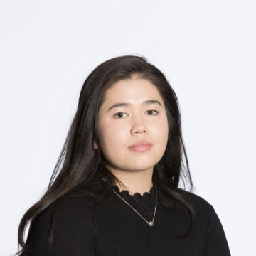 Woman with long dark hair looking at camera