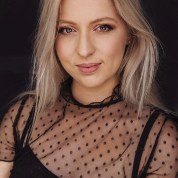 Woman with blonde hair smiling to camera