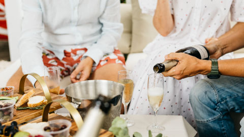 Someone pouring champagne